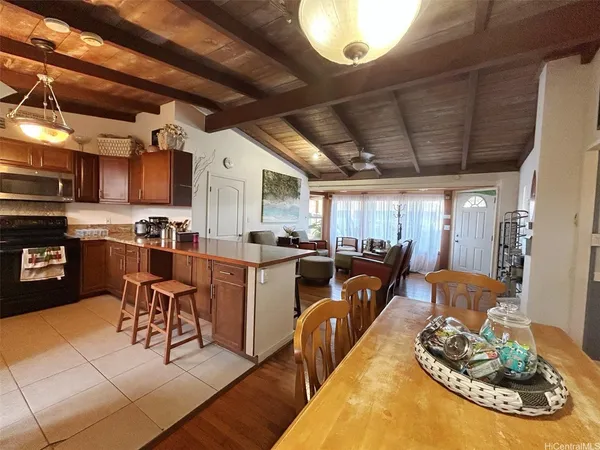 a living room with lots of furniture and kitchen view