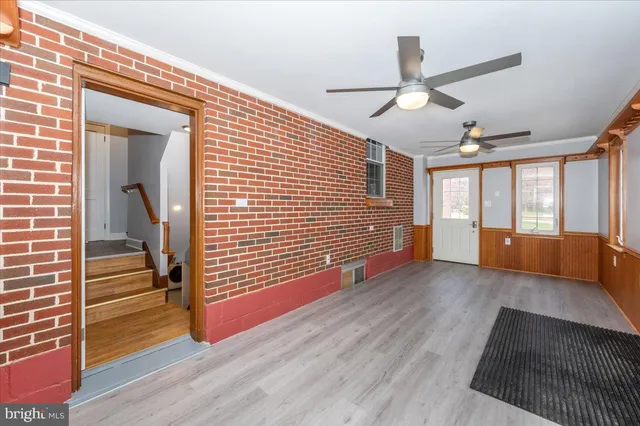 a view of an entryway with wooden floor