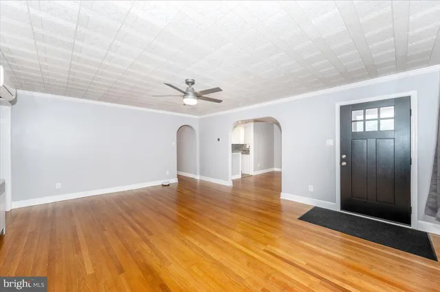 a view of empty room with wooden floor