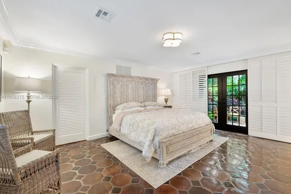 a bedroom with a large bed and a window