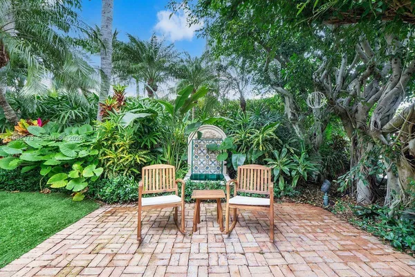 a chairs and bench in a garden
