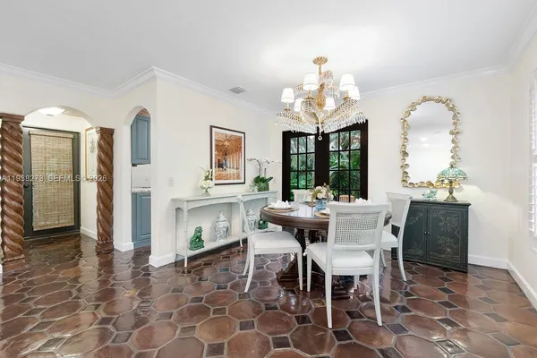 a view of a dining room with furniture and a chandelier