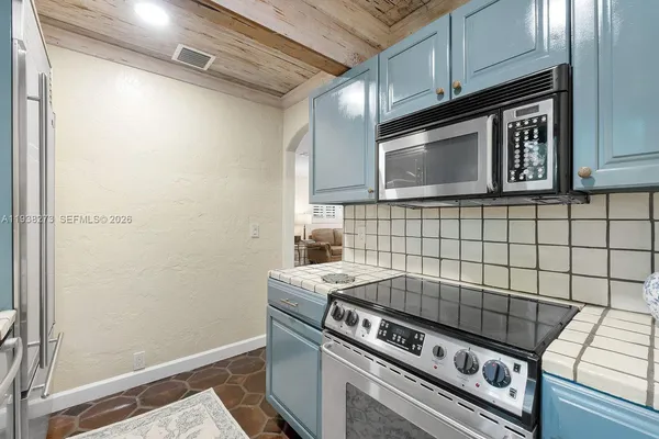 a stove top oven sitting inside of a kitchen