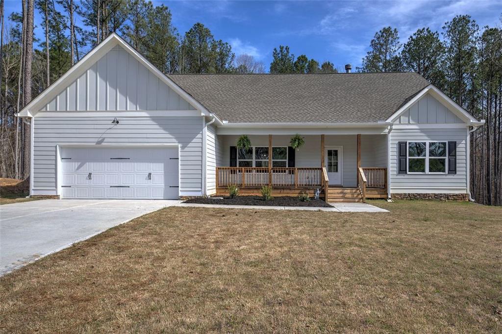 148 Rivers Edge Drive Chatsworth, GA 30705 - Photo 1 of 1 a front view of a house with a yard and garage