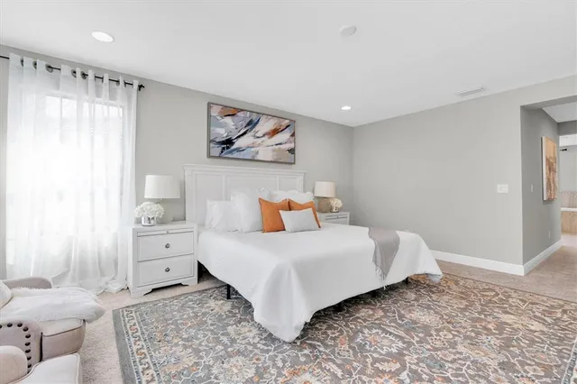 a spacious bathroom with a double vanity sink and a bathtub