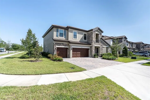 a front view of a house with a yard and garage