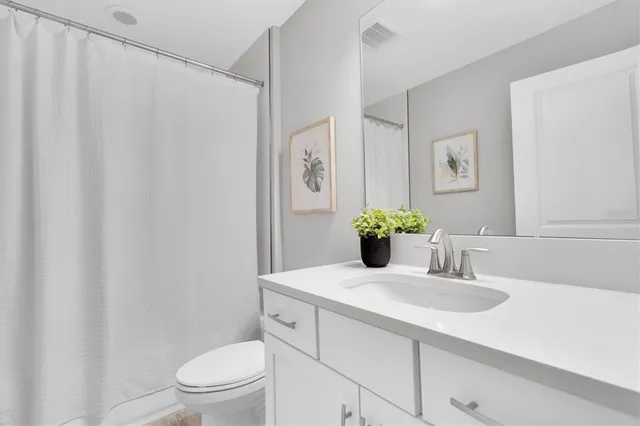 an empty room with a cabinet and mirrors