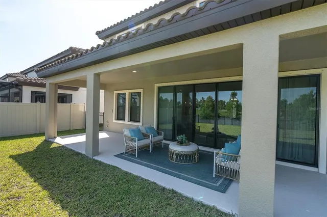 a view of a field with large trees