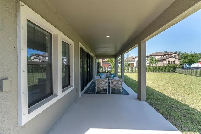 a view of a house with garden and lawn chairs