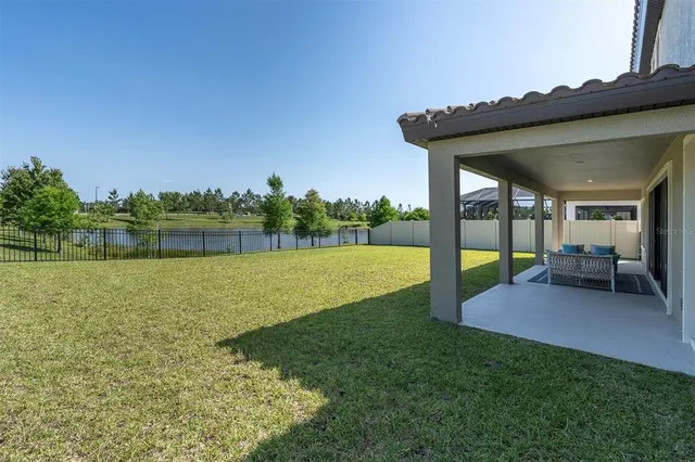 a house with huge green field in front of it