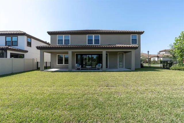 a view of a house with swimming pool and a yard
