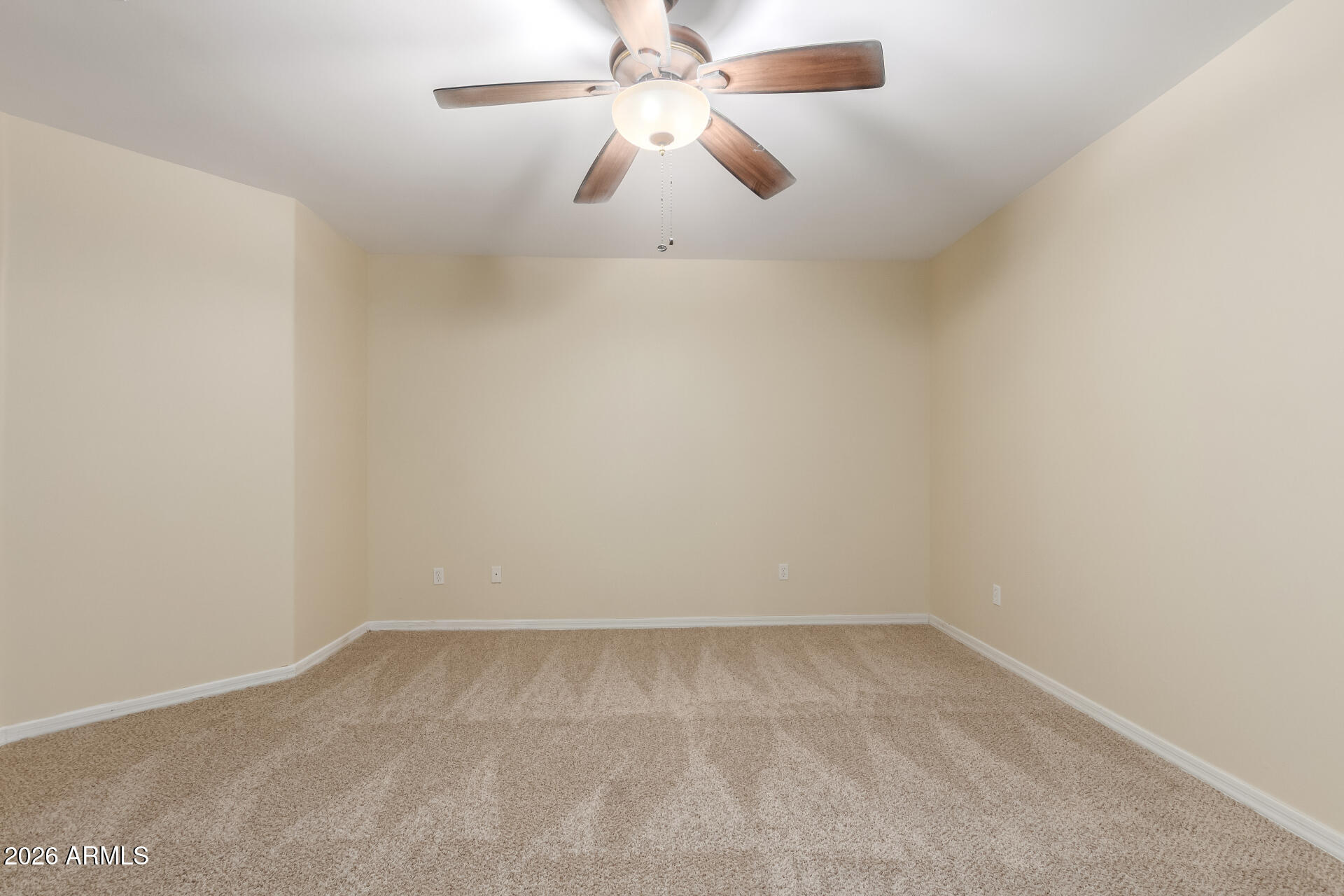 6202 East McKellips Road, Unit 115 Mesa, AZ 85215 - Photo 25 of 43 an empty room with a ceiling fan and fan