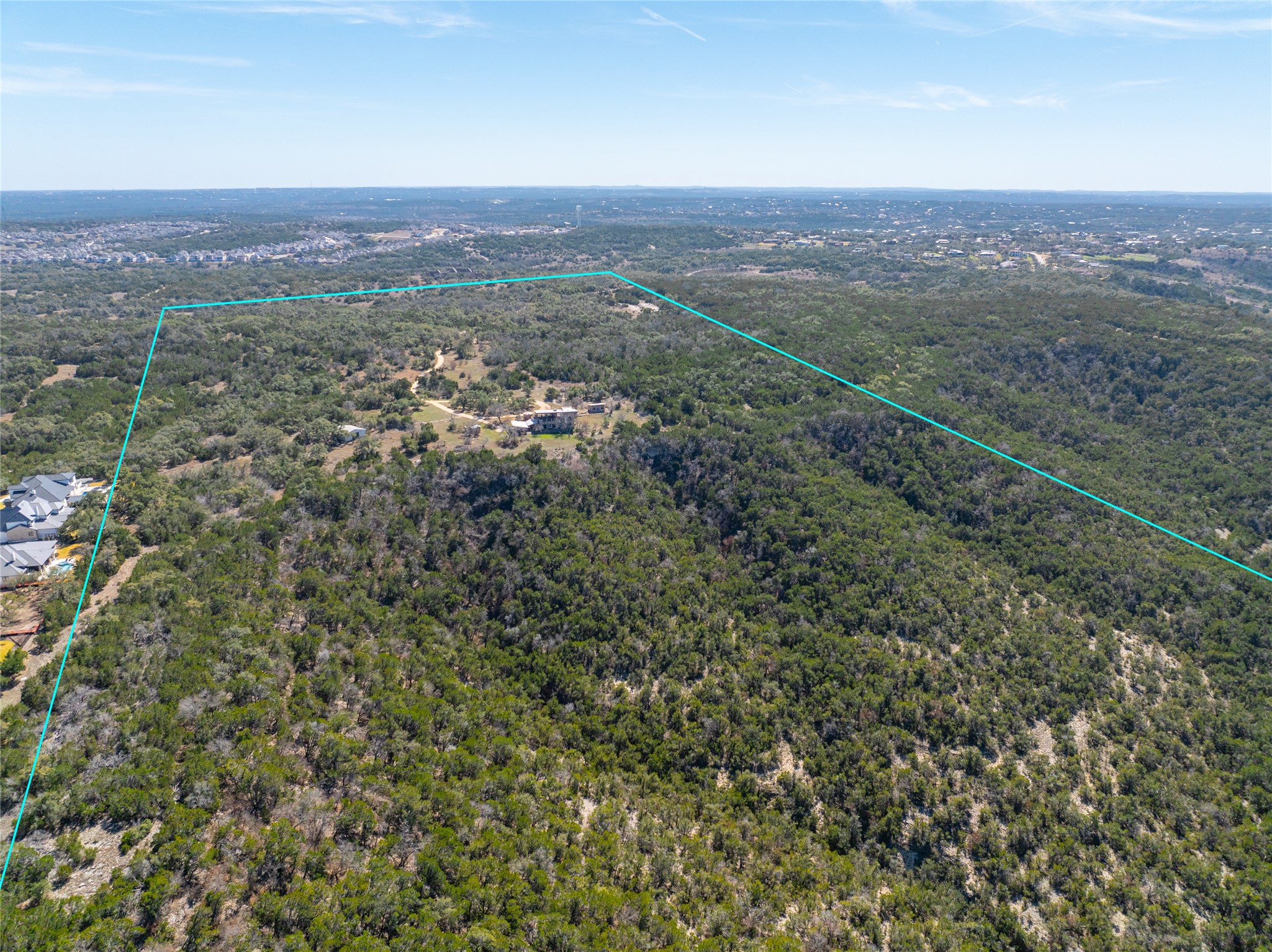 17318 Hamilton Pool Road Austin, TX 78738 - Photo 12 of 21 Lush rolling hills extend to the horizon under a clear blue sky.