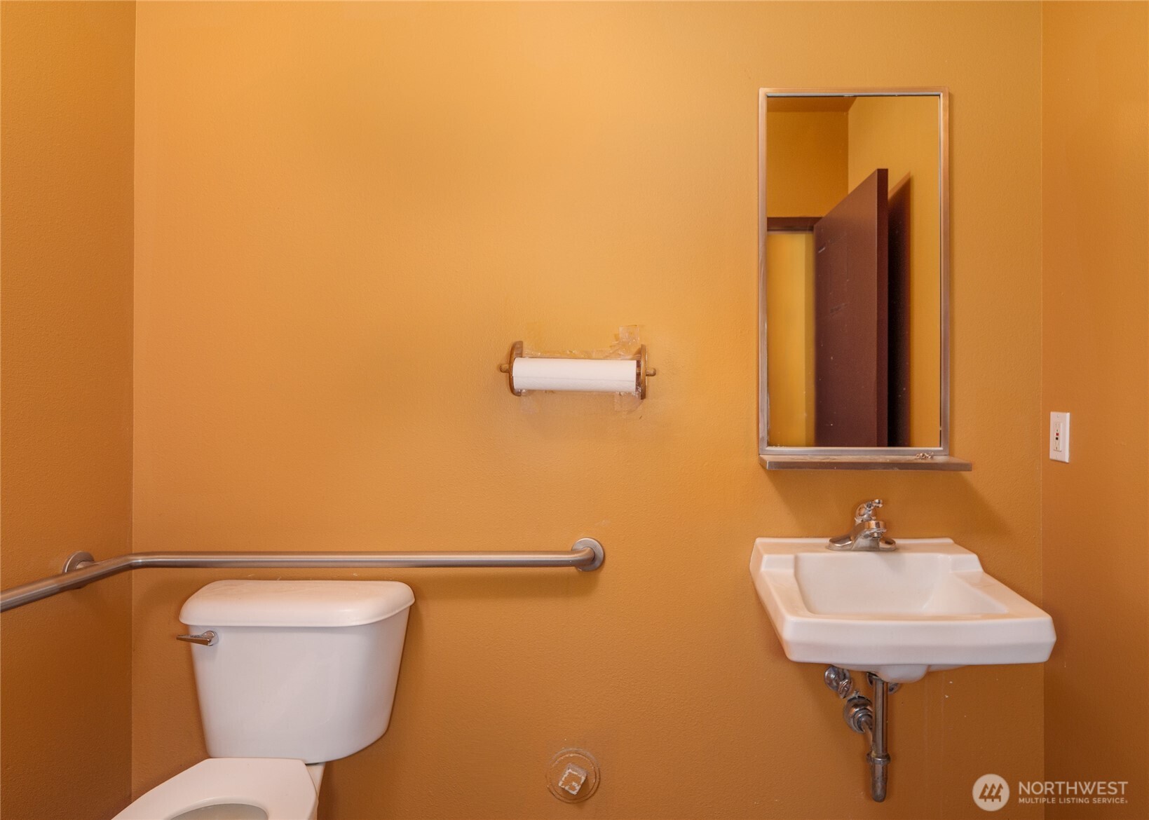 755 West Washington Street, Unit C Sequim, WA 98382 - Photo 19 of 21 a bathroom with a toilet sink and mirror