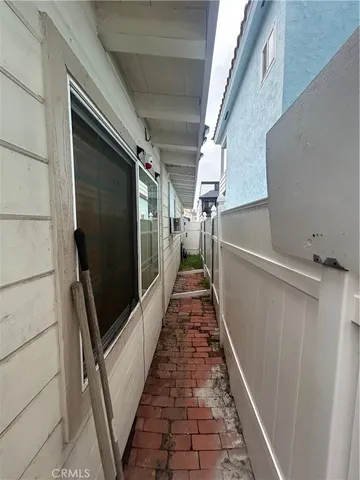 a view of wooden floor in a hall with an entryway