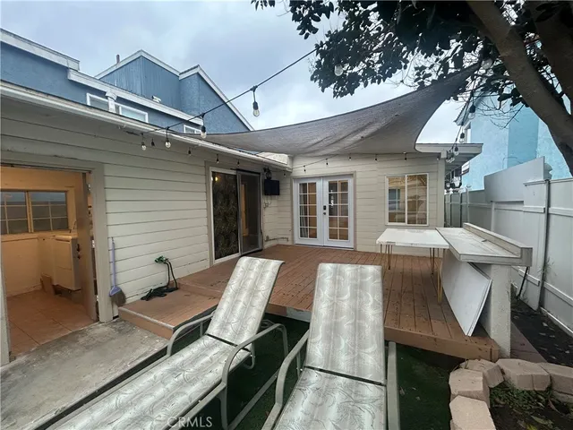 a view of a patio with table and chairs with wooden floor and fence