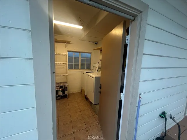 a view of a hallway with granite countertop a refrigerator