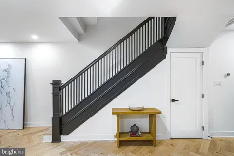 a view of a hallway with wooden floor and entryway