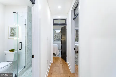 a bathroom with a glass shower door and a toilet