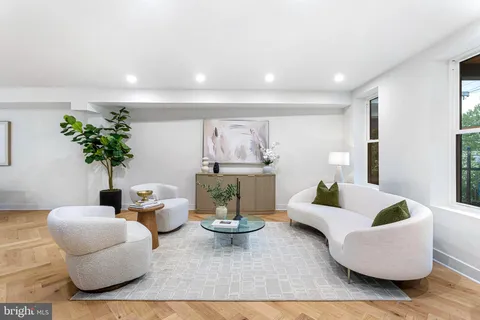 a living room with furniture and a potted plant