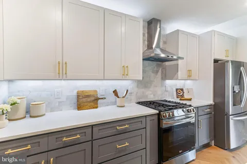 a kitchen with stainless steel appliances a sink stove and refrigerator