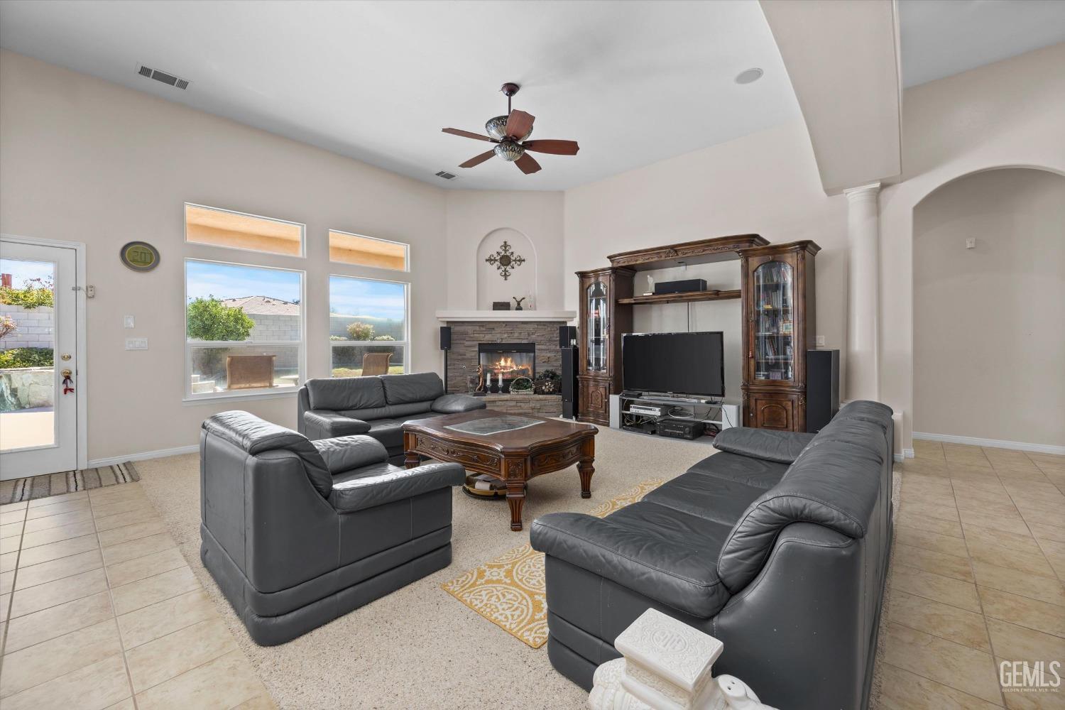 Undisclosed Address Bakersfield, CA 93312 - Photo 13 of 50 a living room with furniture fireplace and a large window