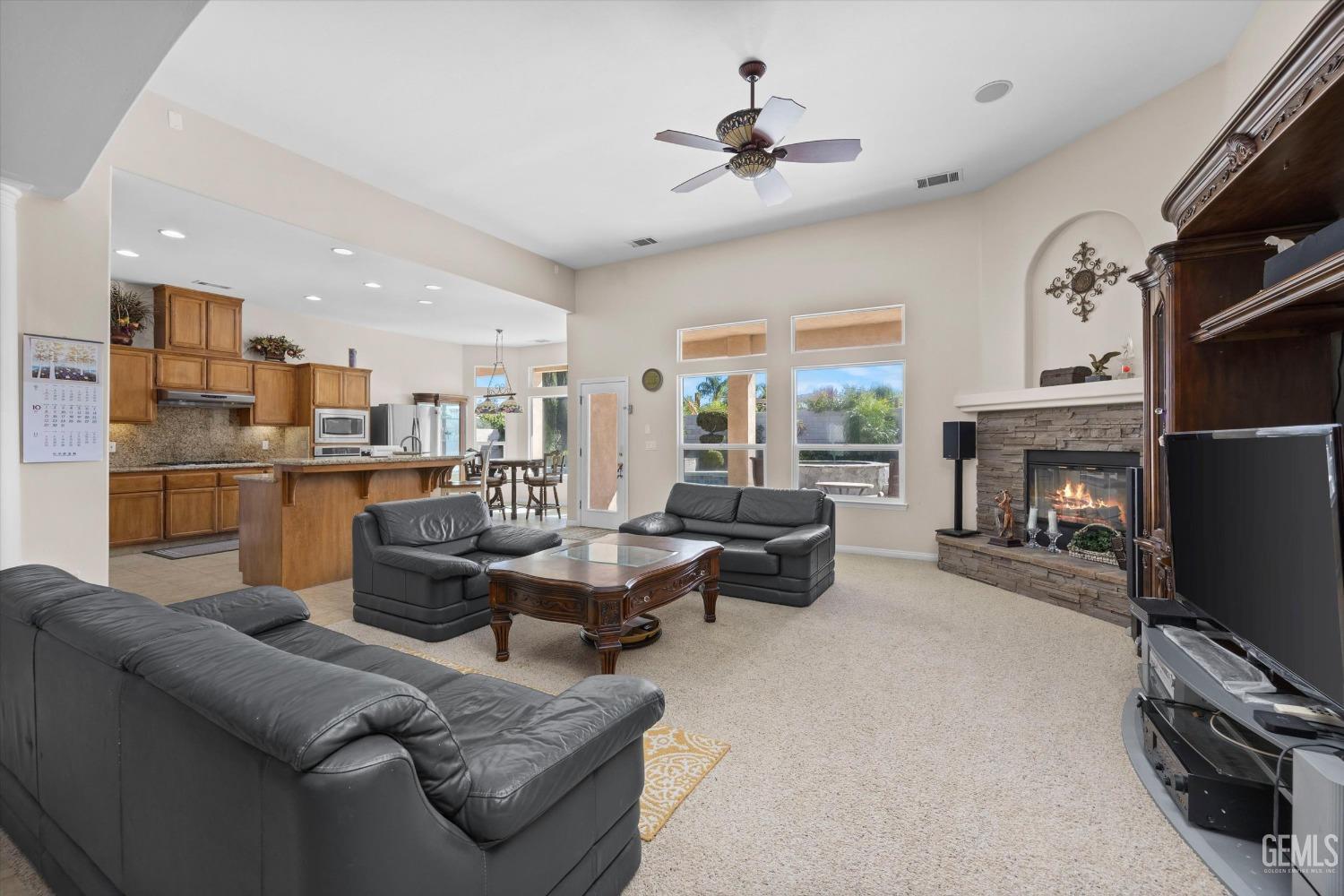 Undisclosed Address Bakersfield, CA 93312 - Photo 15 of 50 a living room with furniture a fireplace and a flat screen tv