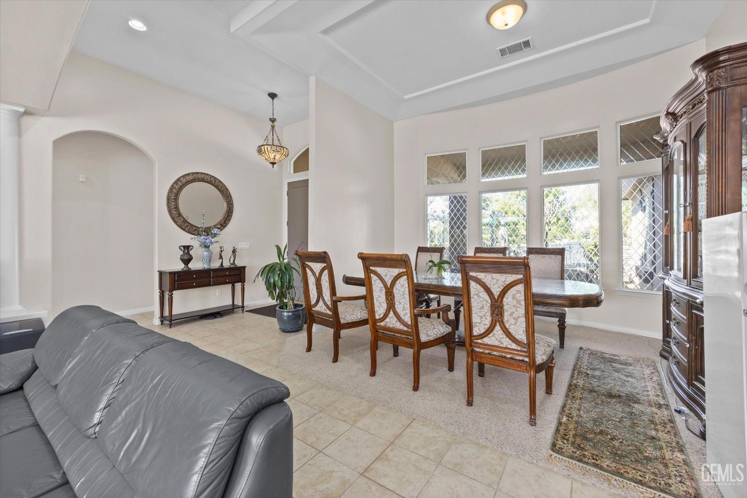 Undisclosed Address Bakersfield, CA 93312 - Photo 20 of 50 a living room with furniture a rug potted plant windows and a large window