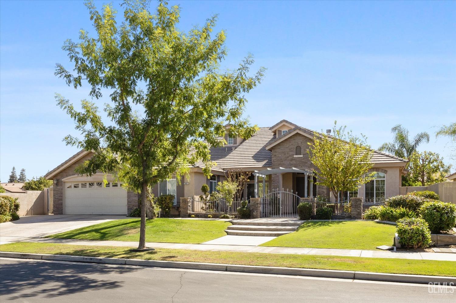 Undisclosed Address Bakersfield, CA 93312 - Photo 2 of 50 a view of a house with garden and trees