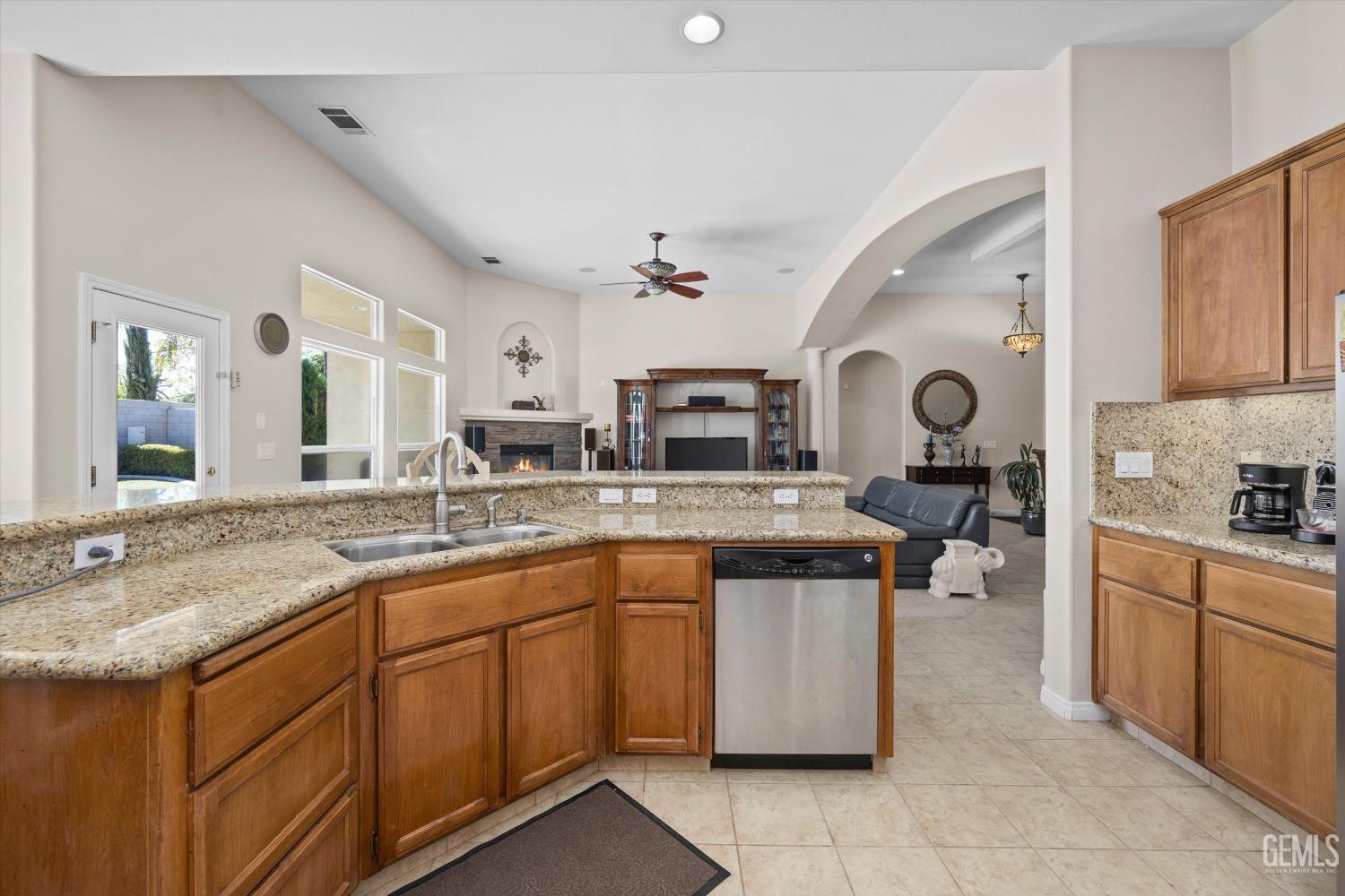 Undisclosed Address Bakersfield, CA 93312 - Photo 26 of 50 a kitchen with a sink stove and cabinets
