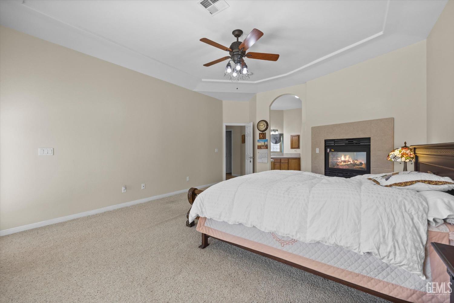 Undisclosed Address Bakersfield, CA 93312 - Photo 28 of 50 a bedroom with a bed and a ceiling fan