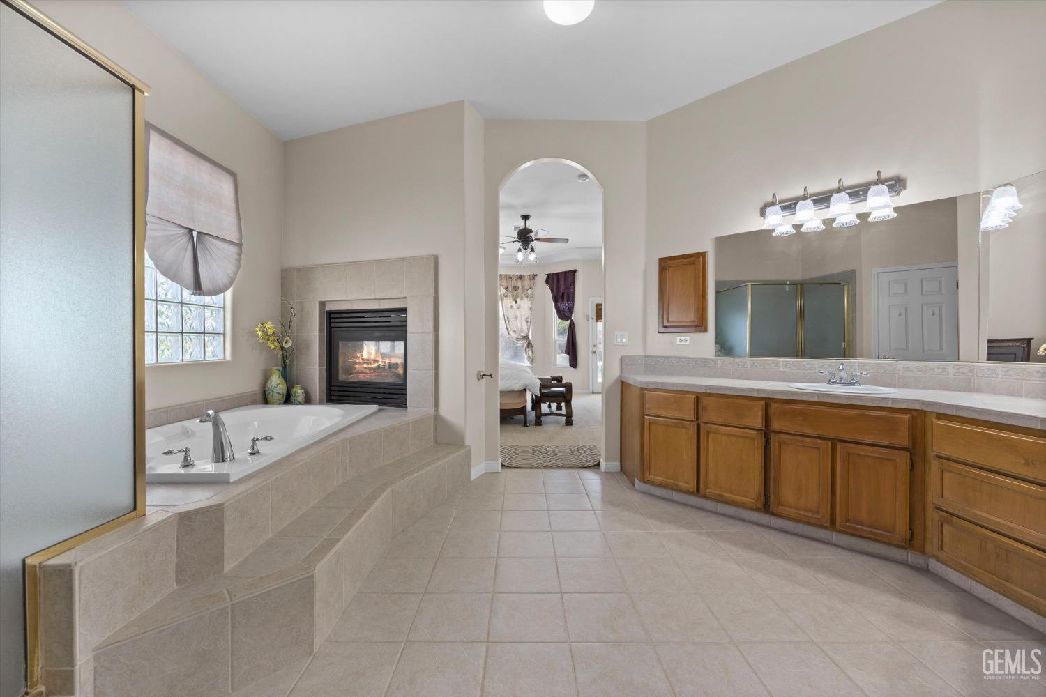 Undisclosed Address Bakersfield, CA 93312 - Photo 33 of 50 a spacious en suite spacious with a large bed and a dresser