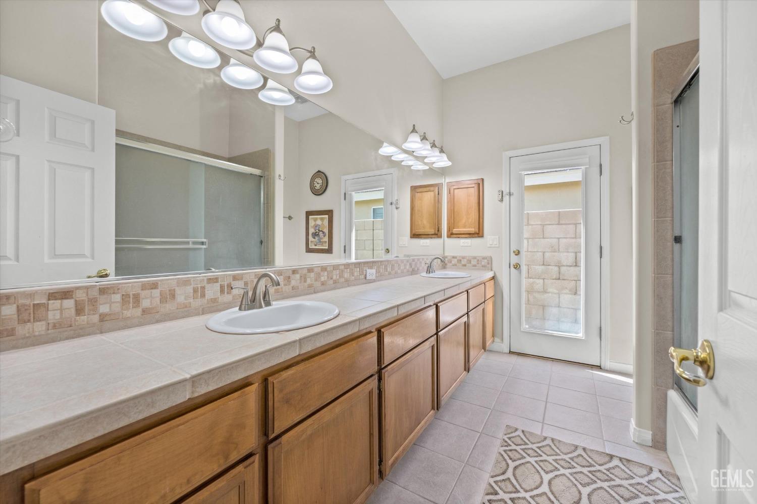 Undisclosed Address Bakersfield, CA 93312 - Photo 36 of 50 a spacious bathroom with a granite countertop double vanity and a mirror