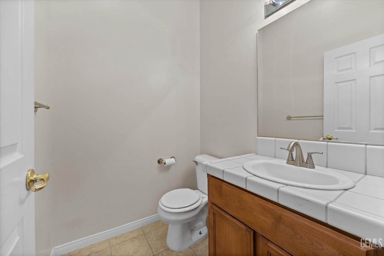 Undisclosed Address Bakersfield, CA 93312 - Photo 37 of 50 a bathroom with a sink a toilet and mirror