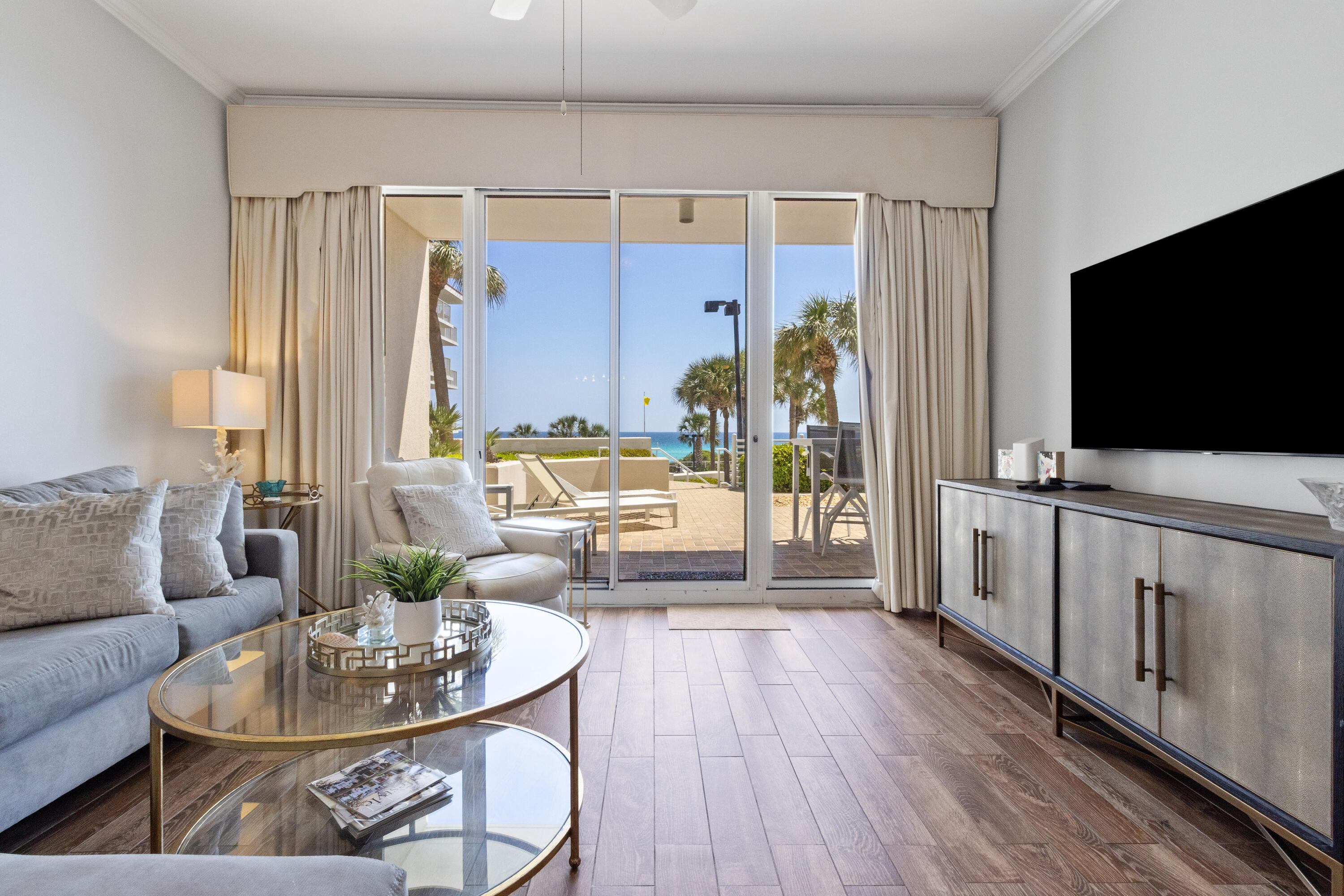 550 Tops'l Beach Boulevard, Unit 103 Miramar Beach, FL 32550 - Photo 8 of 20 a living room with furniture and a flat screen tv