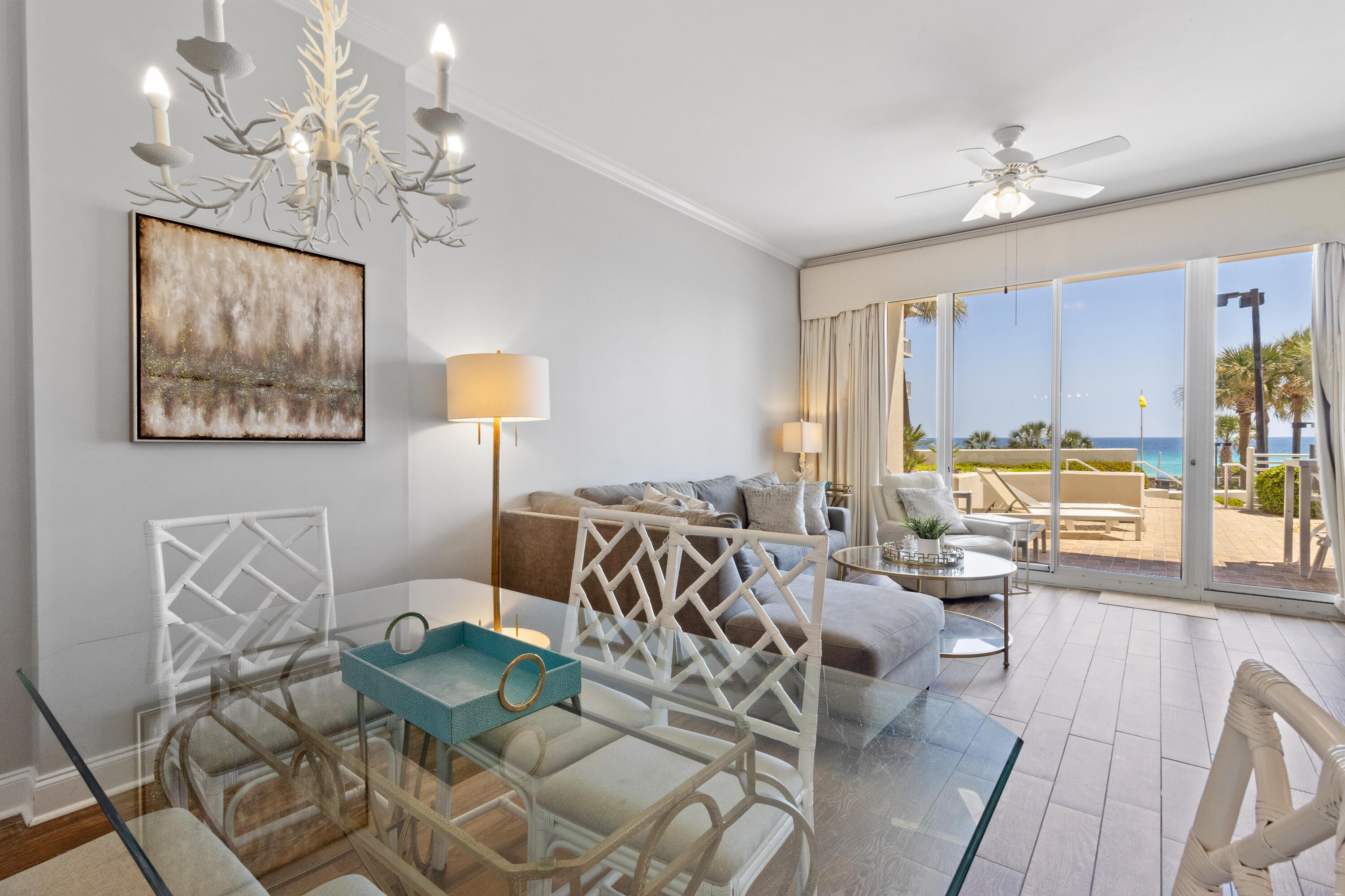 550 Tops'l Beach Boulevard, Unit 103 Miramar Beach, FL 32550 - Photo 9 of 20 a living room with furniture a chandelier and a large mirror