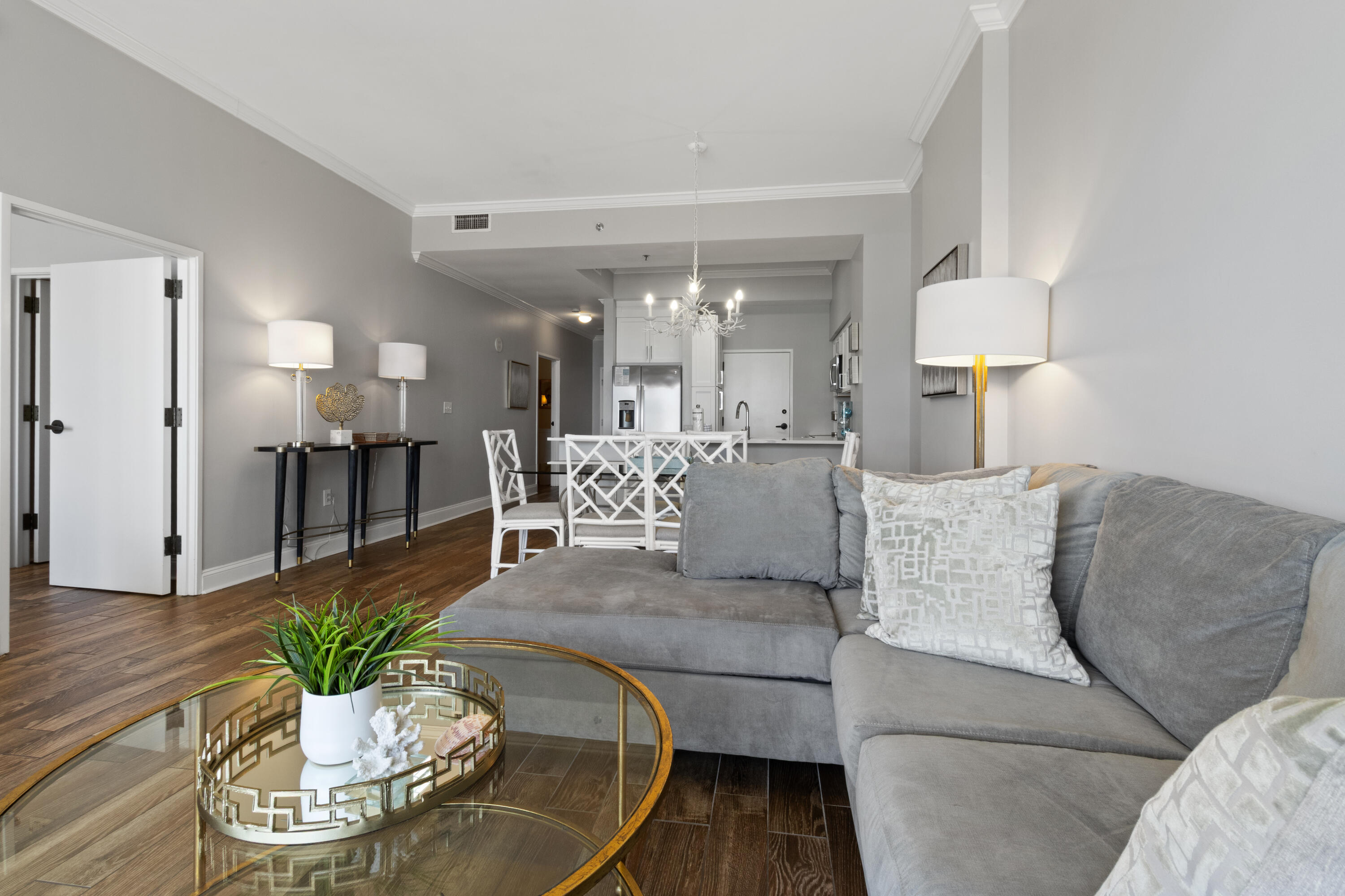 550 Tops'l Beach Boulevard, Unit 103 Miramar Beach, FL 32550 - Photo 10 of 20 a living room with furniture white and a chandelier