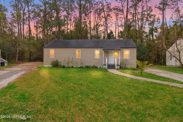 a front view of house with yard and trees