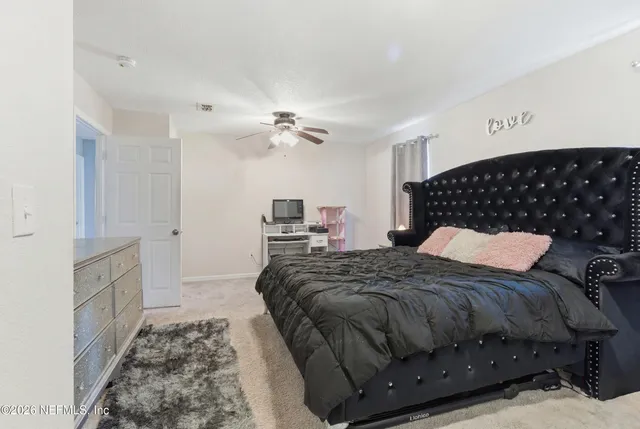 a bedroom with a bed and cabinets
