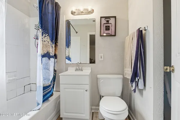 a bathroom with a toilet sink and tub