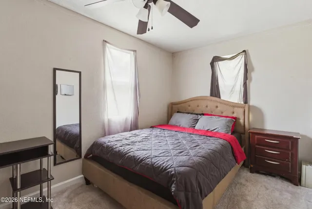 a bedroom with a bed a desk and chair