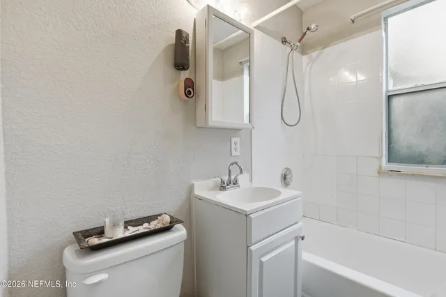 a bathroom with a shower a sink and a mirror