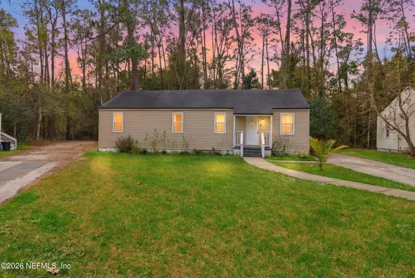 a front view of house with yard and trees