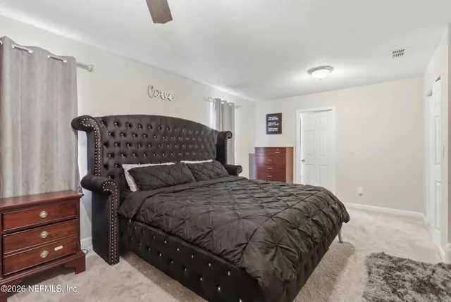 a bedroom with a bed and a dresser