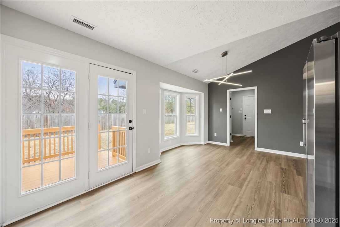 122 Tanner Loop Raeford, NC 28376 - Photo 14 of 36 a view of an empty room with glass door and windows