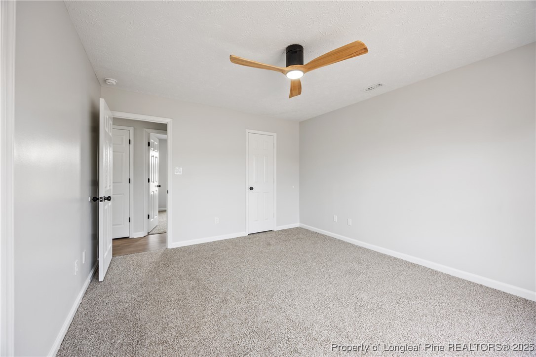 122 Tanner Loop Raeford, NC 28376 - Photo 16 of 36 an empty room with a ceiling fan and window