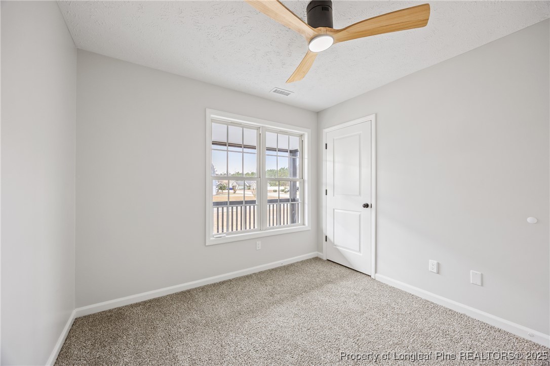 122 Tanner Loop Raeford, NC 28376 - Photo 22 of 36 an empty room with windows and fan