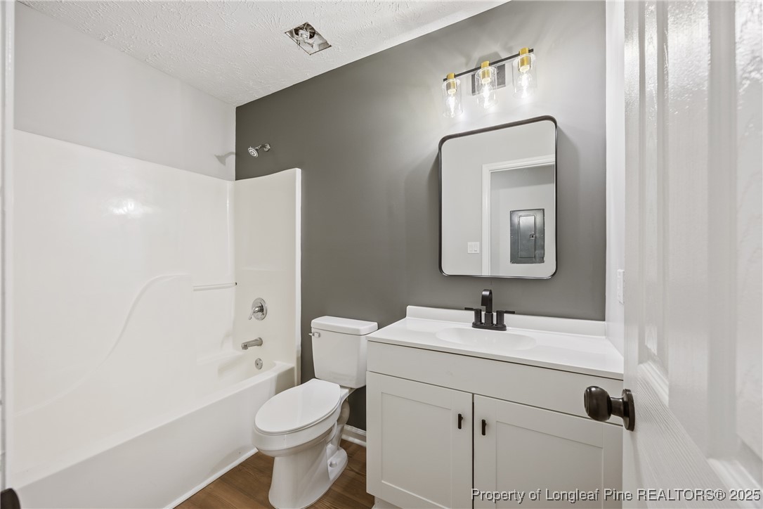 122 Tanner Loop Raeford, NC 28376 - Photo 26 of 36 a bathroom with a toilet sink and mirror