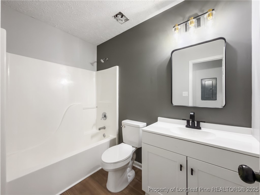 122 Tanner Loop Raeford, NC 28376 - Photo 27 of 36 a bathroom with a toilet sink a mirror and shower