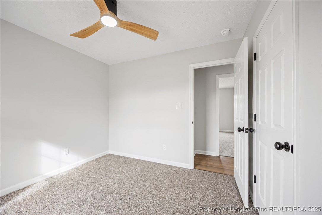 122 Tanner Loop Raeford, NC 28376 - Photo 30 of 36 an empty room with closet and a chandelier fan